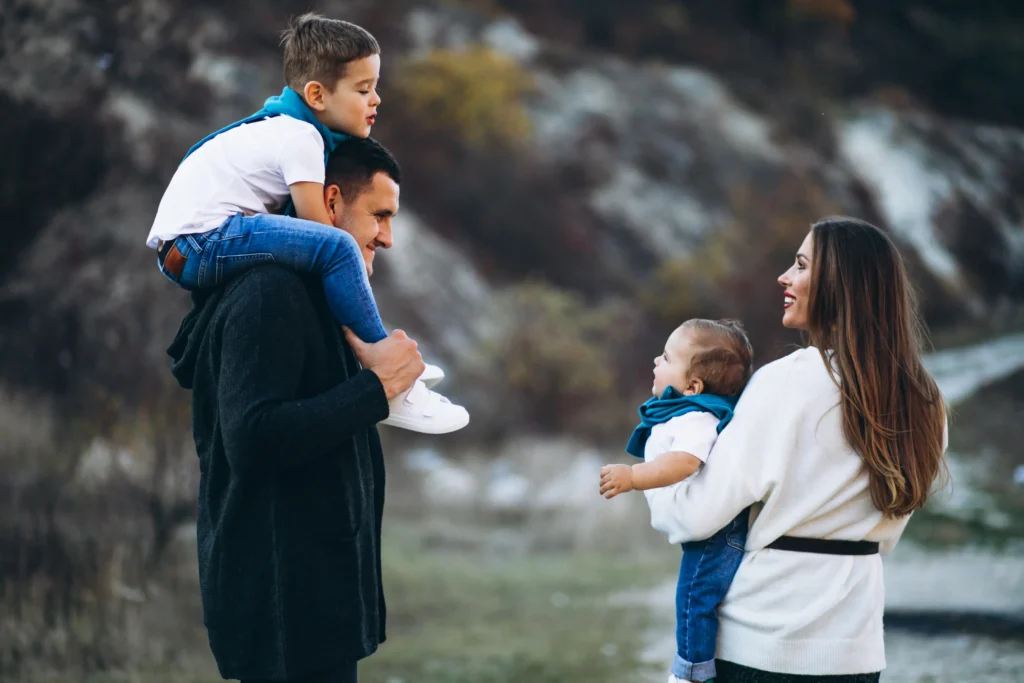Family enjoying time outdoors with two young children